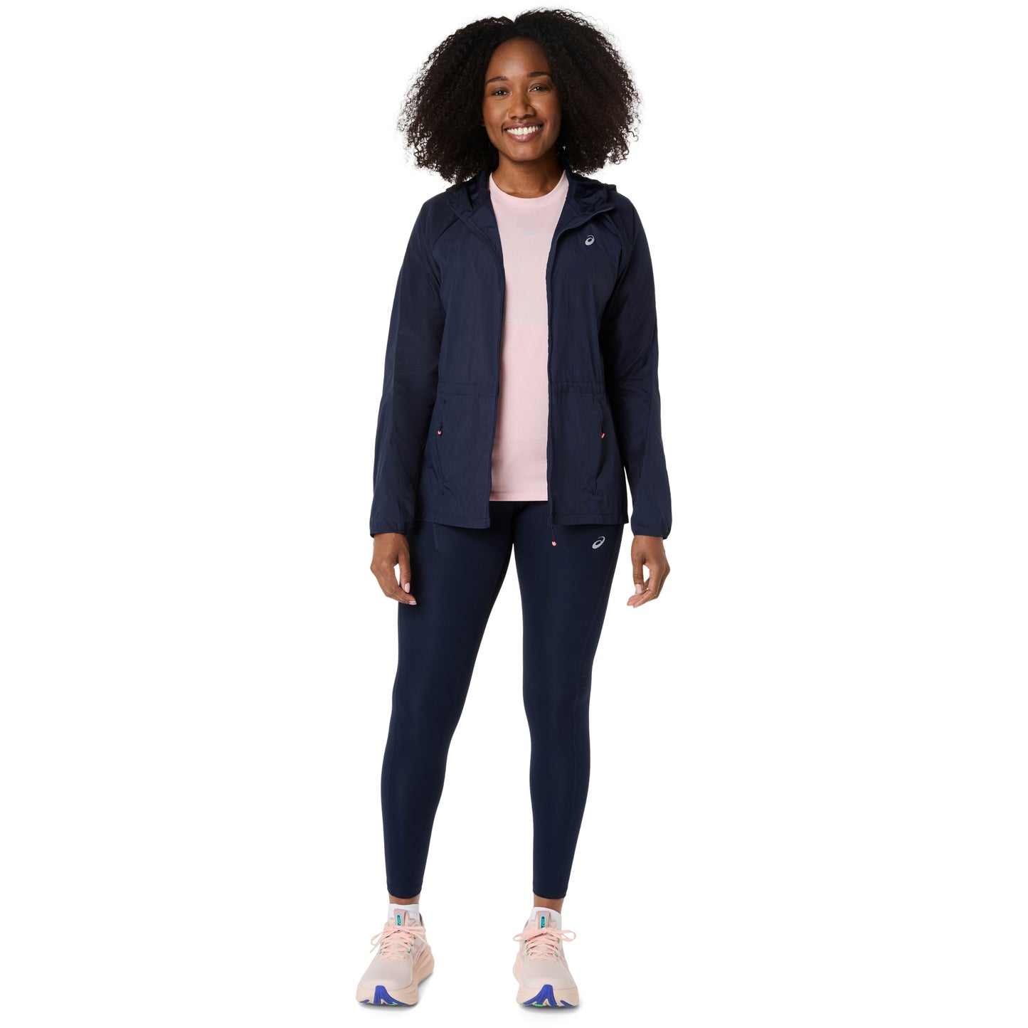 Person wearing a navy jacket andAsics tights on a white background