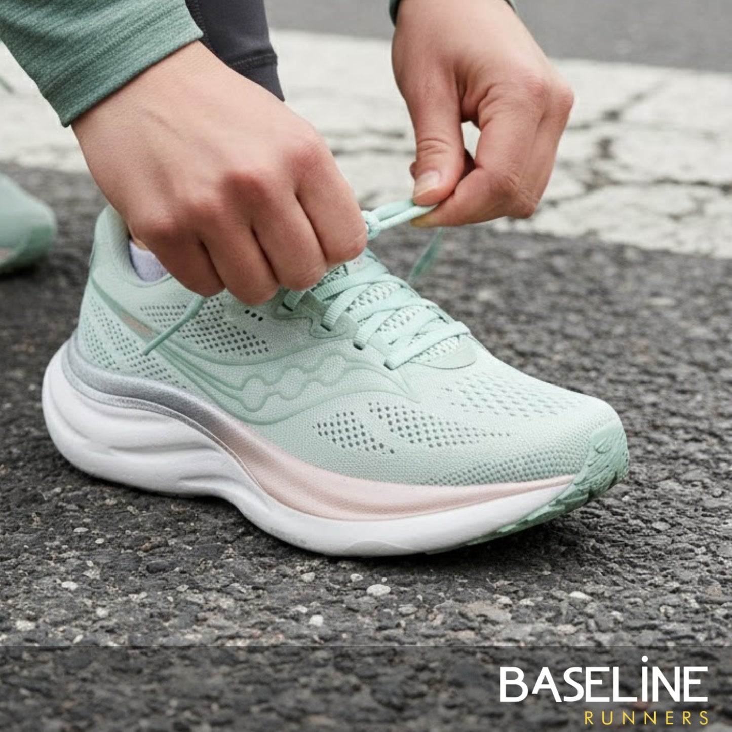 Person tying a light green running shoe on a pavement background with 'Baseline Runners' branding.
