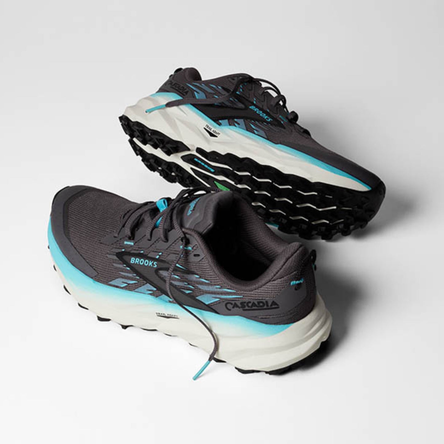 Pair of black and blue Brooks running shoes on a light gray background