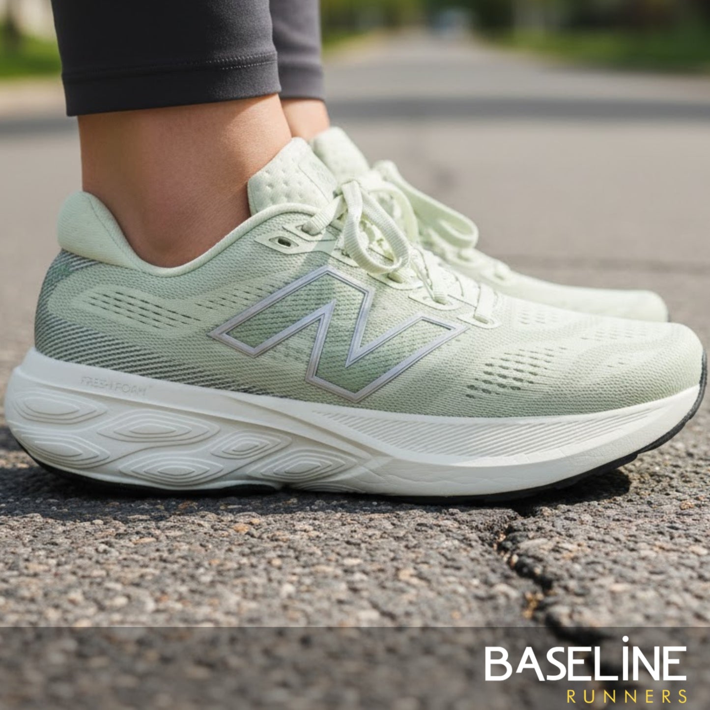 Light green running shoe with New Balance logo on a road, featuring 'Baseline Runners' branding.