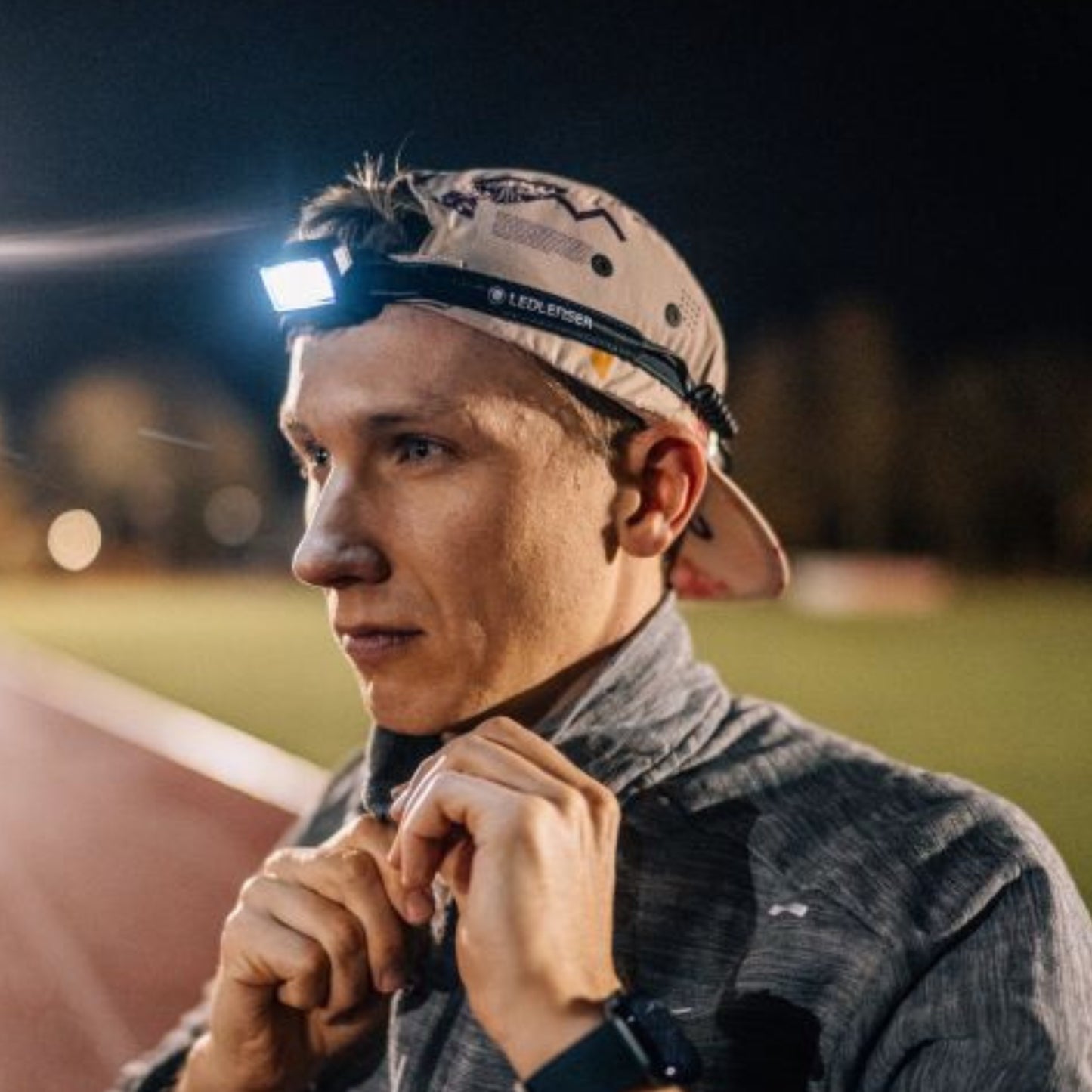 Person wearing a headlamp outdoors at night
