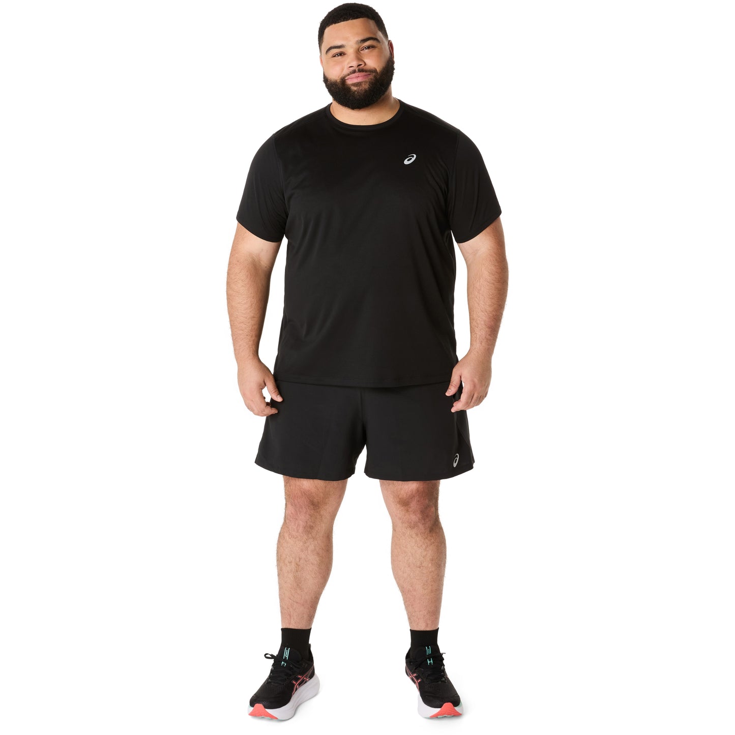 Man wearing a black athletic outfit with a logo on a white background