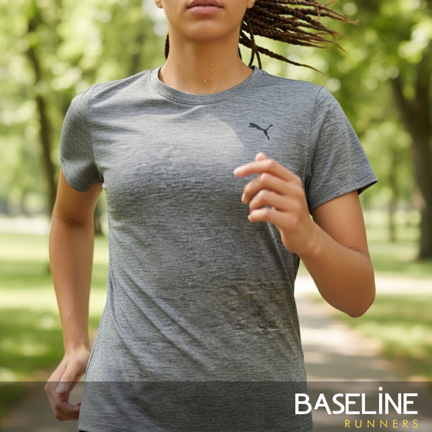 Person wearing a gray Puma t-shirt in a park setting