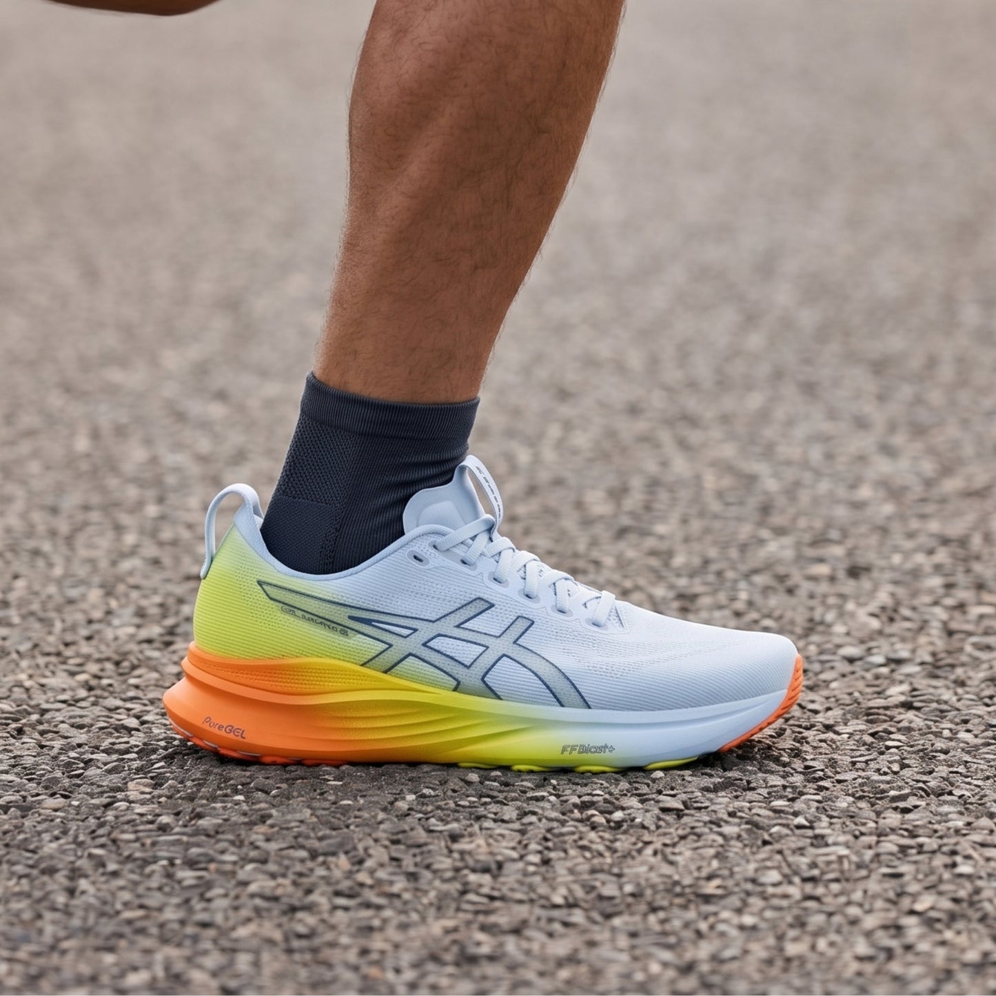 Person running with white and yellow Asics shoes with orange accents on a white background