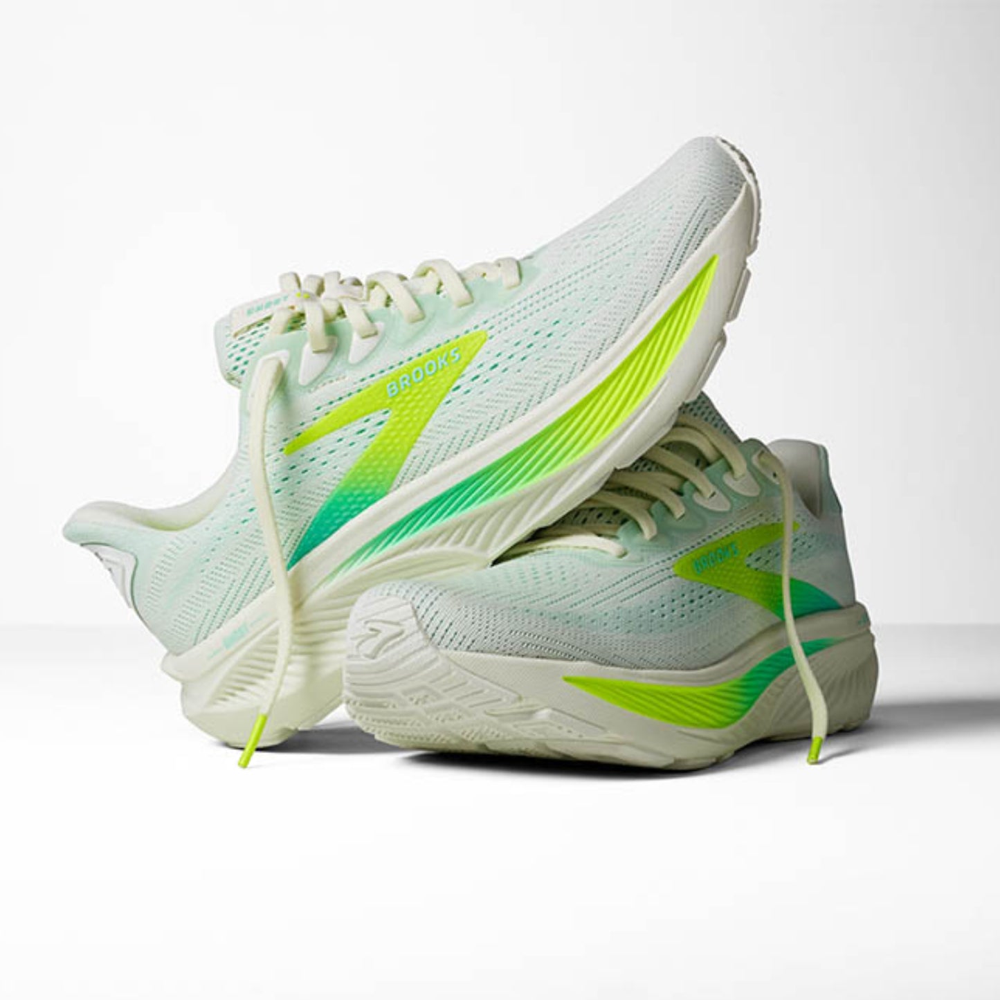 Light blue Brooks running shoes with green accents on a white background