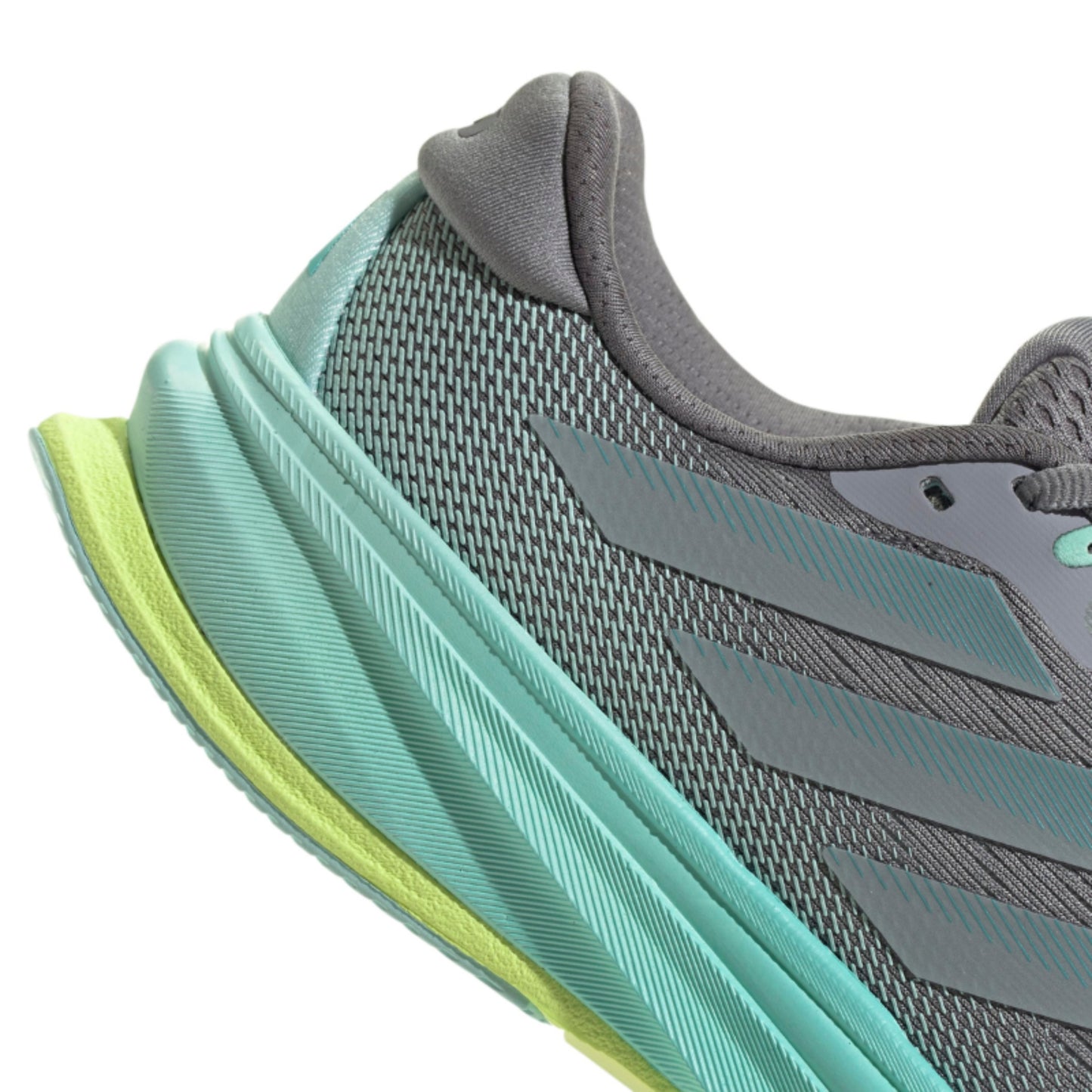 Close-up of a gray and green running shoe on a white background