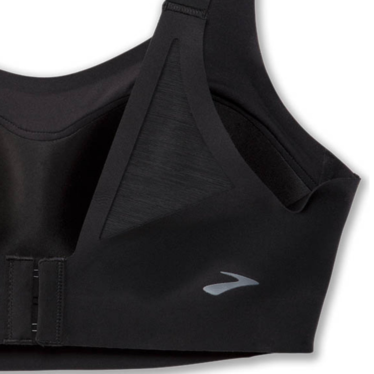 Close-up of a black sports bra showing the underband closure and a small silver logo on the side, set against a plain white background.