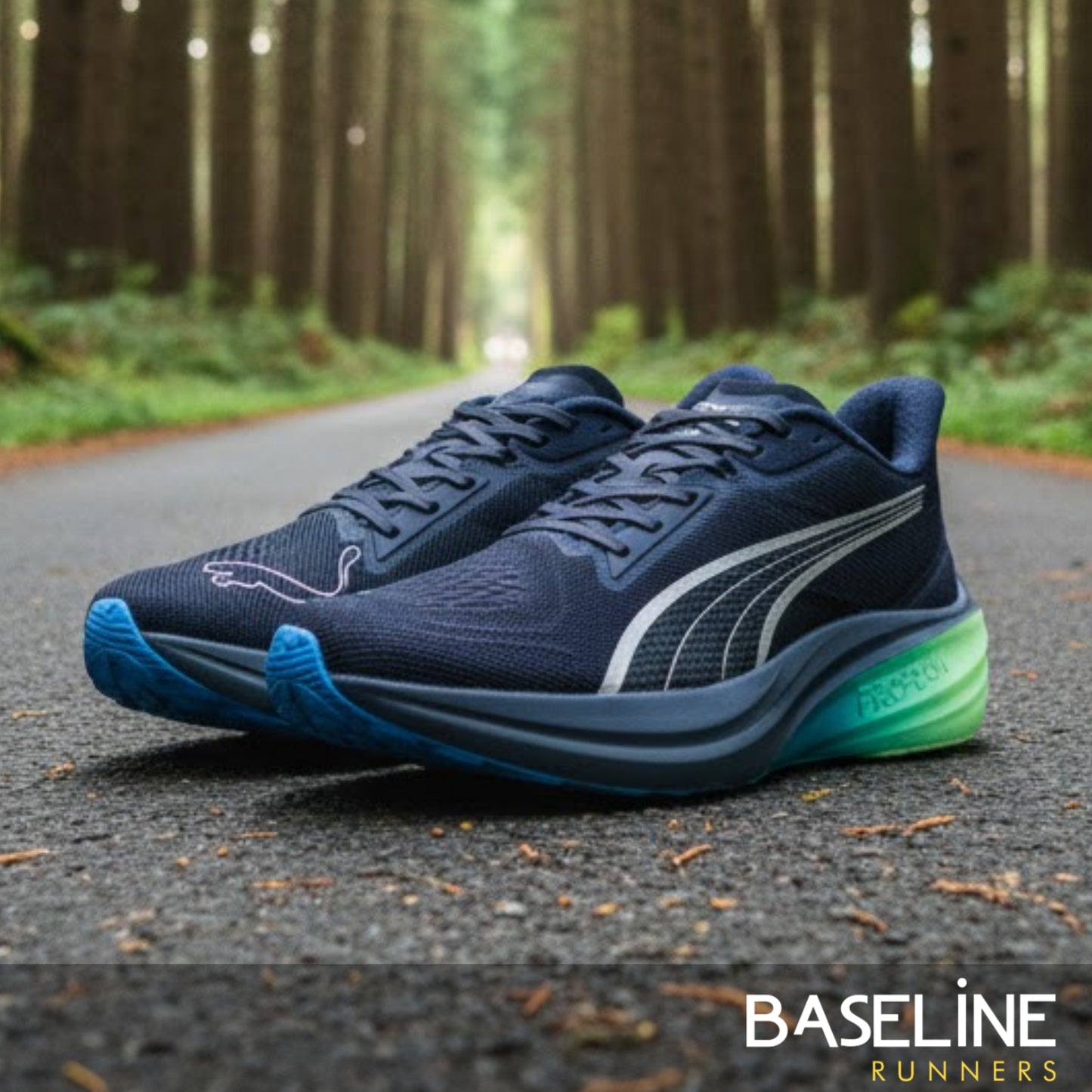 Navy running shoes with green sole on a forest path, featuring the Baseline Runners brand.
