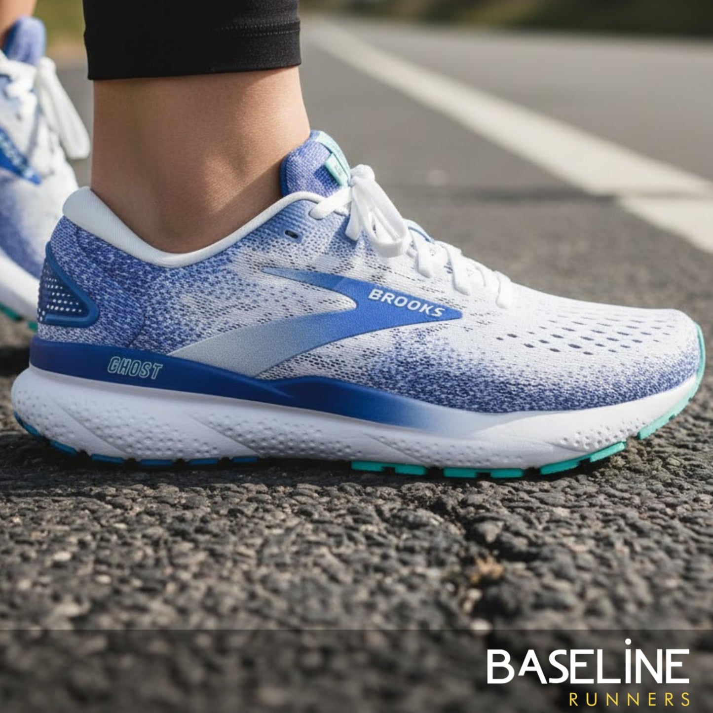 Blue and white running shoe with 'Brooks' branding on a road.