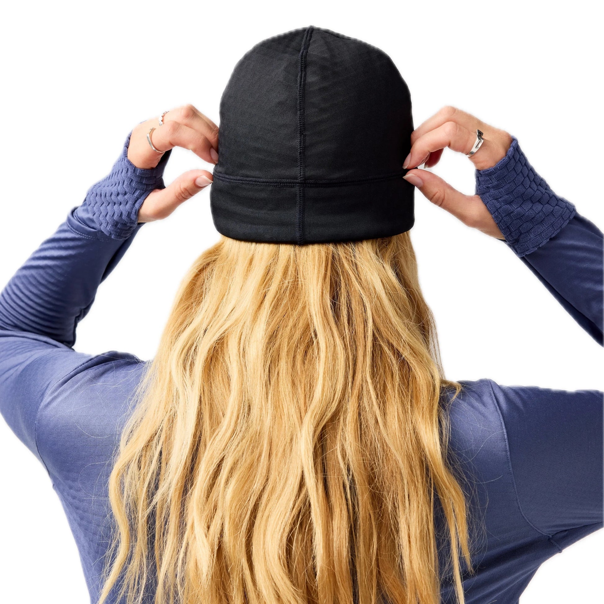 Woman wearing black Brooks beanie on a white background