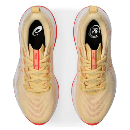 Pair of light orange running shoes with red accents on a white background