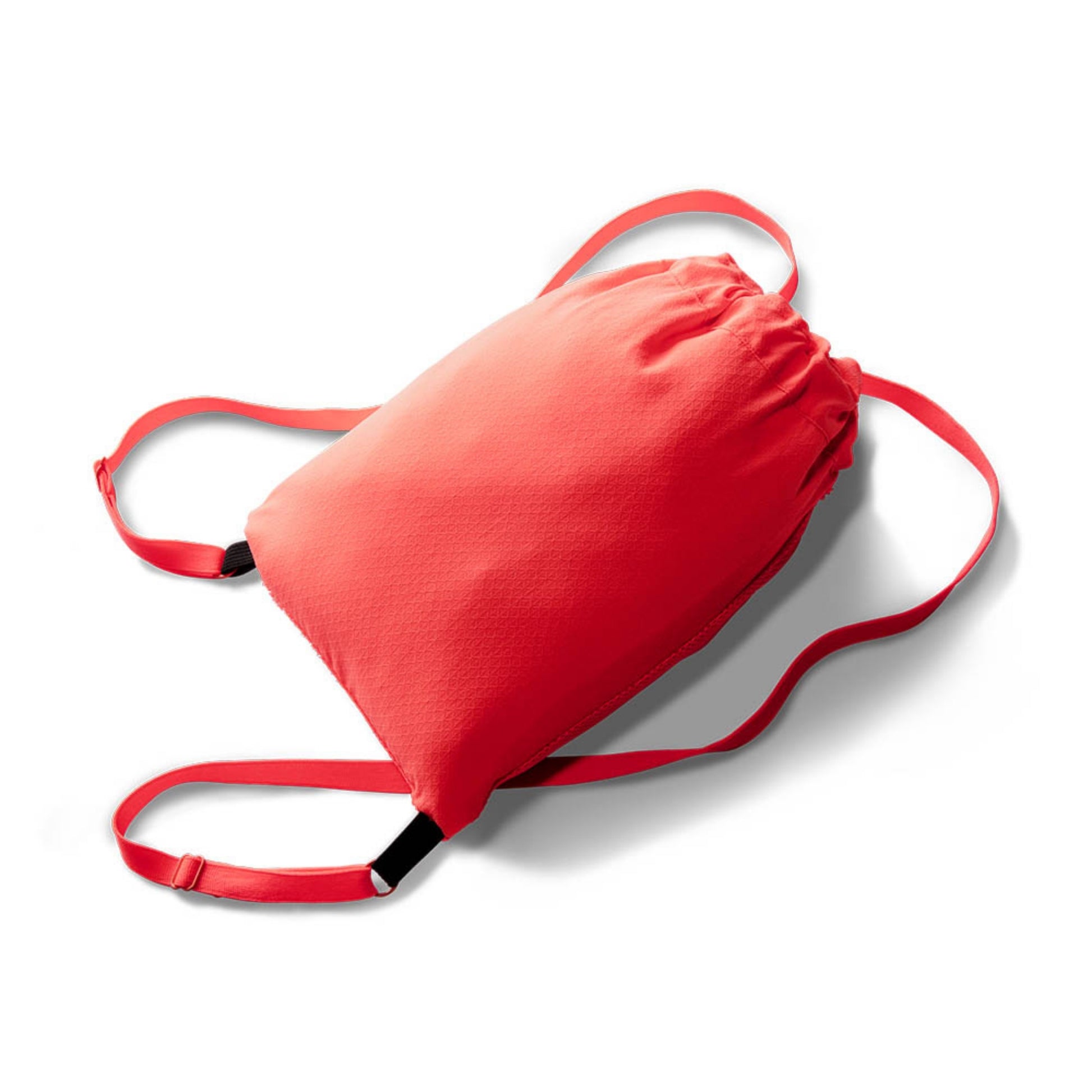 A small orange bag containing the jacket on a white background