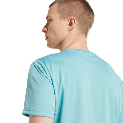 A man wearing an Adidas mint shirt
