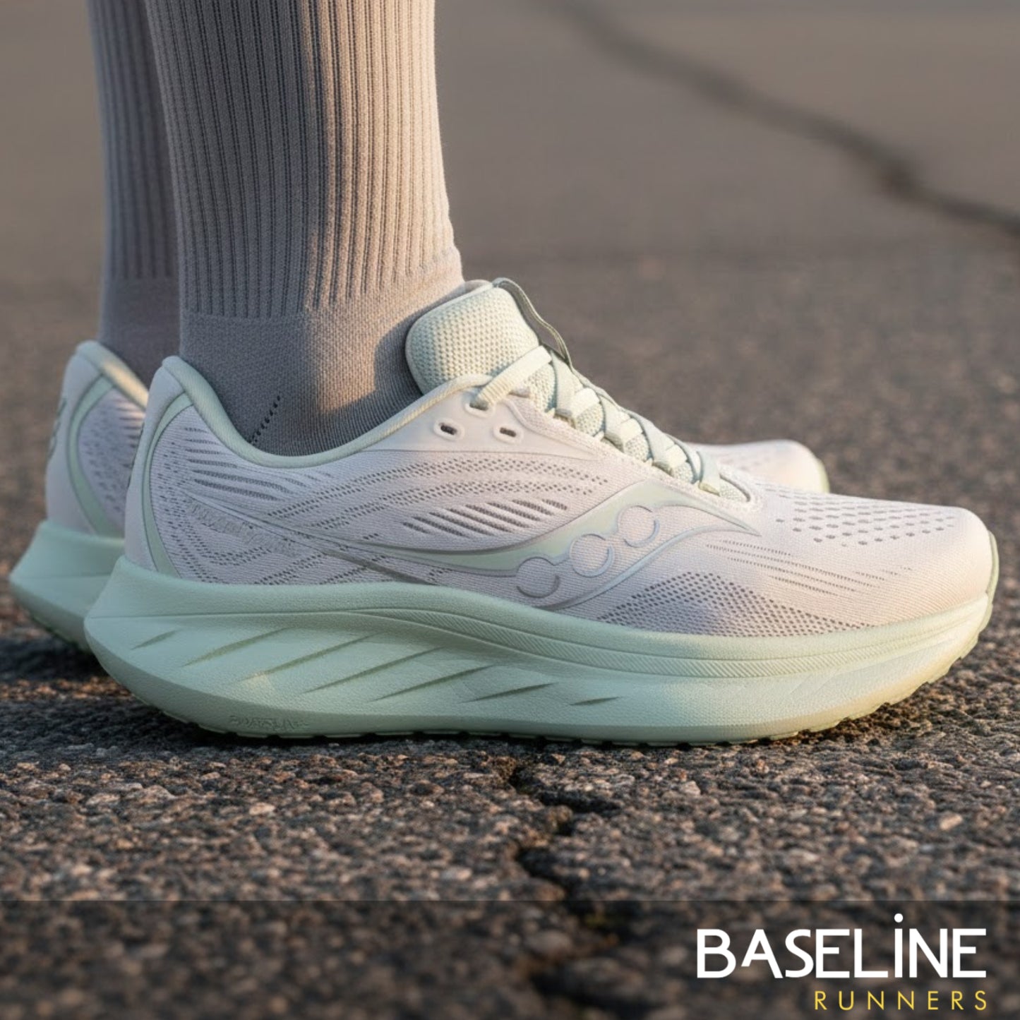 White and light green Saucony running shoe with a light green sole 