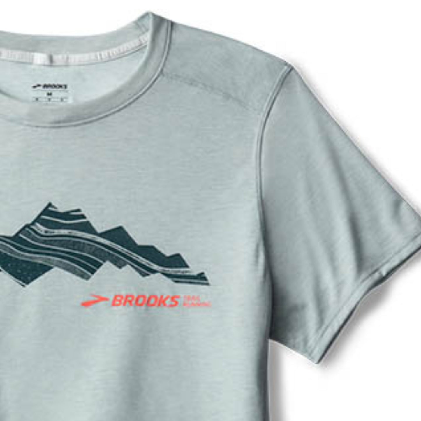 Gray t-shirt with mountain graphic and Brooks logo on a white background