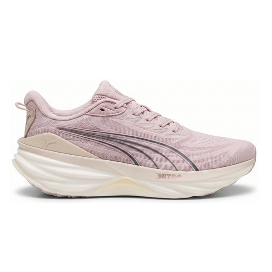 A Puma running shoe in light pink with a thick cream-colored midsole and dark gray S-curved stripes, shown from the side on a white background.
