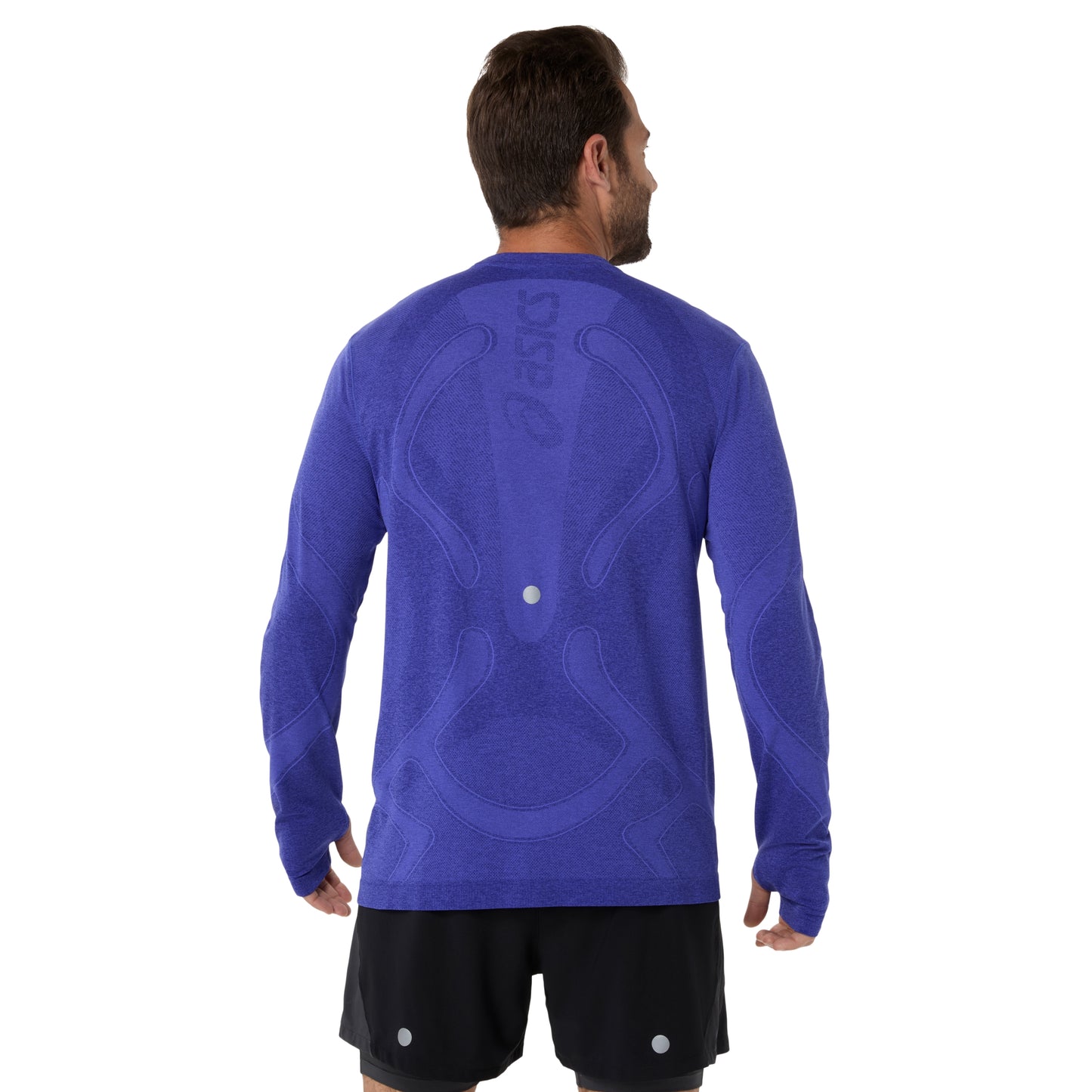 Man wearing a blue long-sleeve athletic shirt with a visible brand logo on a white background