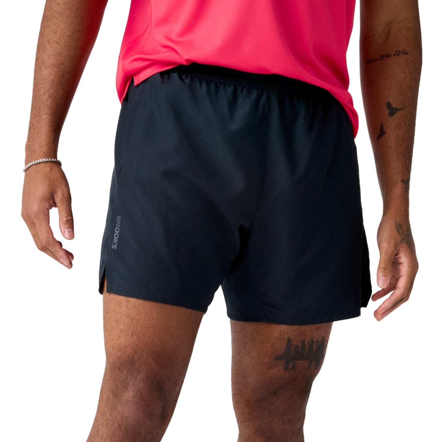 Man wearing black Brooks running shorts on a white background