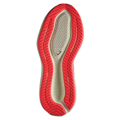 Close-up of a shoe sole with orange tread pattern on a white background
