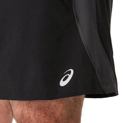 Person wearing black Asics running shorts on a white background 