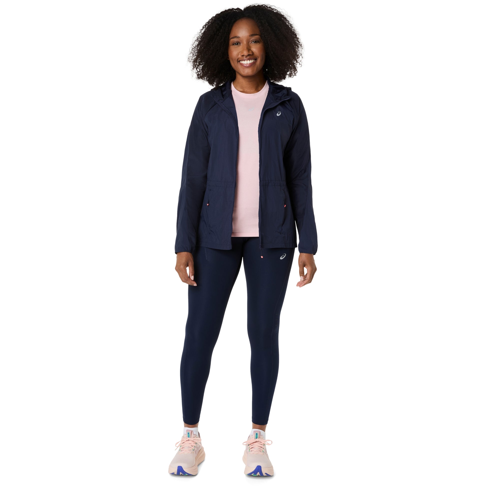 Person wearing a navy jacket andAsics tights on a white background