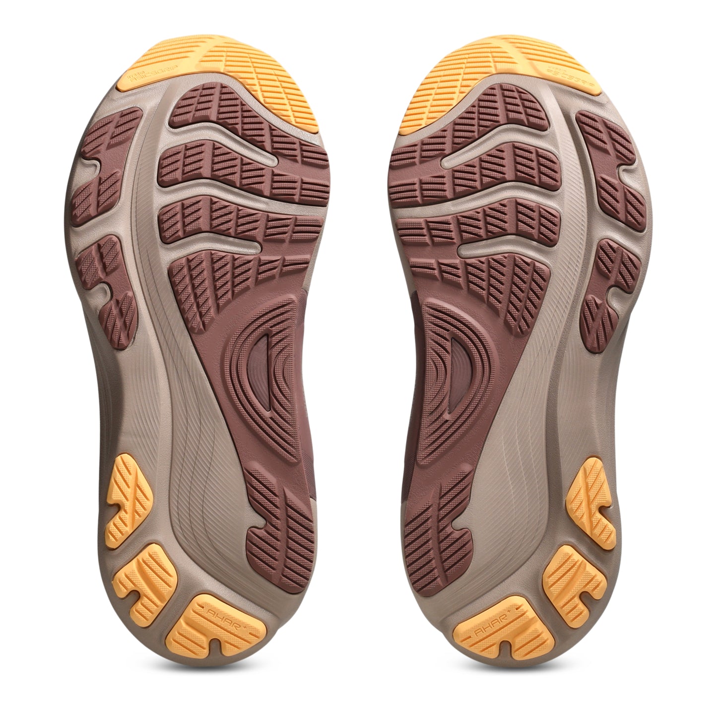 Close-up of the sole of a shoe with a brown and yellow tread pattern on a white background