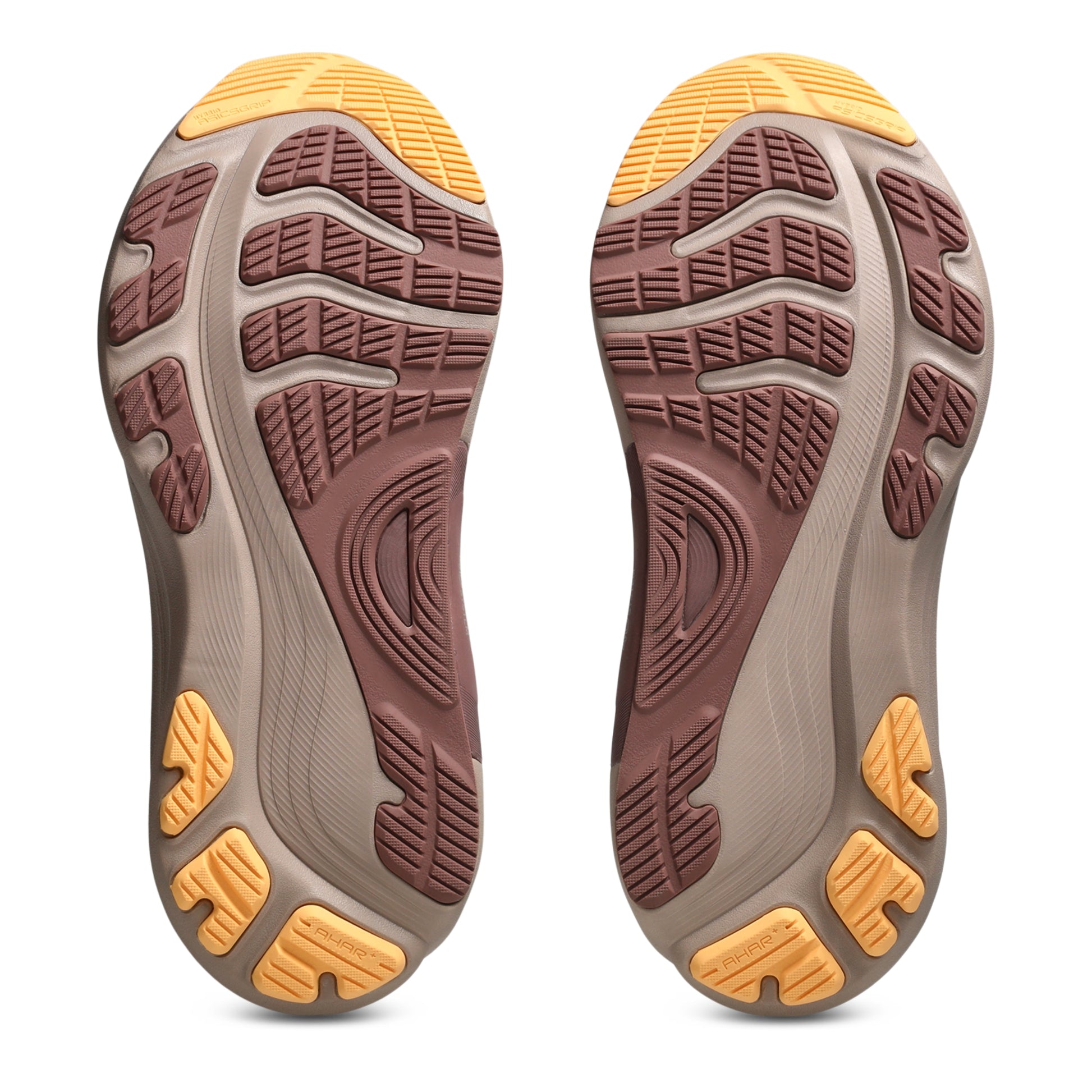 Close-up of the sole of a shoe with a brown and yellow tread pattern on a white background