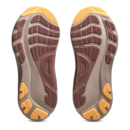 Close-up of the sole of a shoe with a brown and yellow tread pattern on a white background
