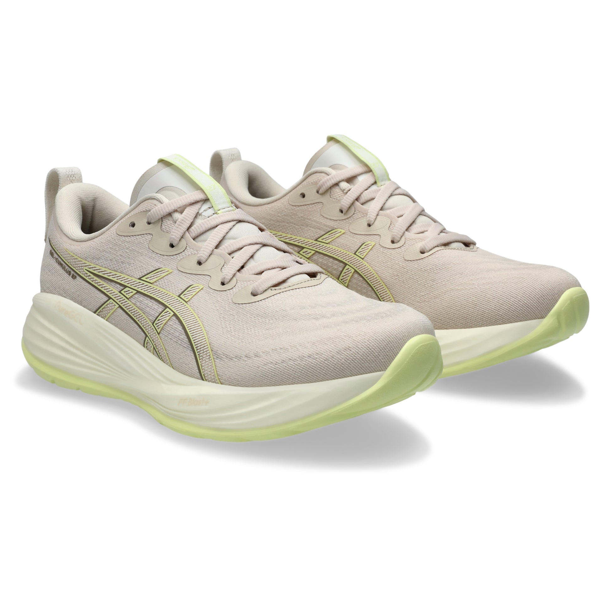 Beige running shoes with green accents on a white background