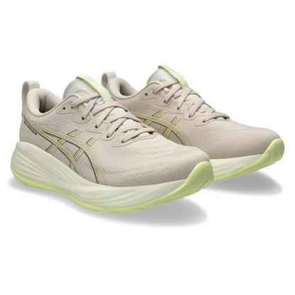 Beige running shoes with green accents on a white background