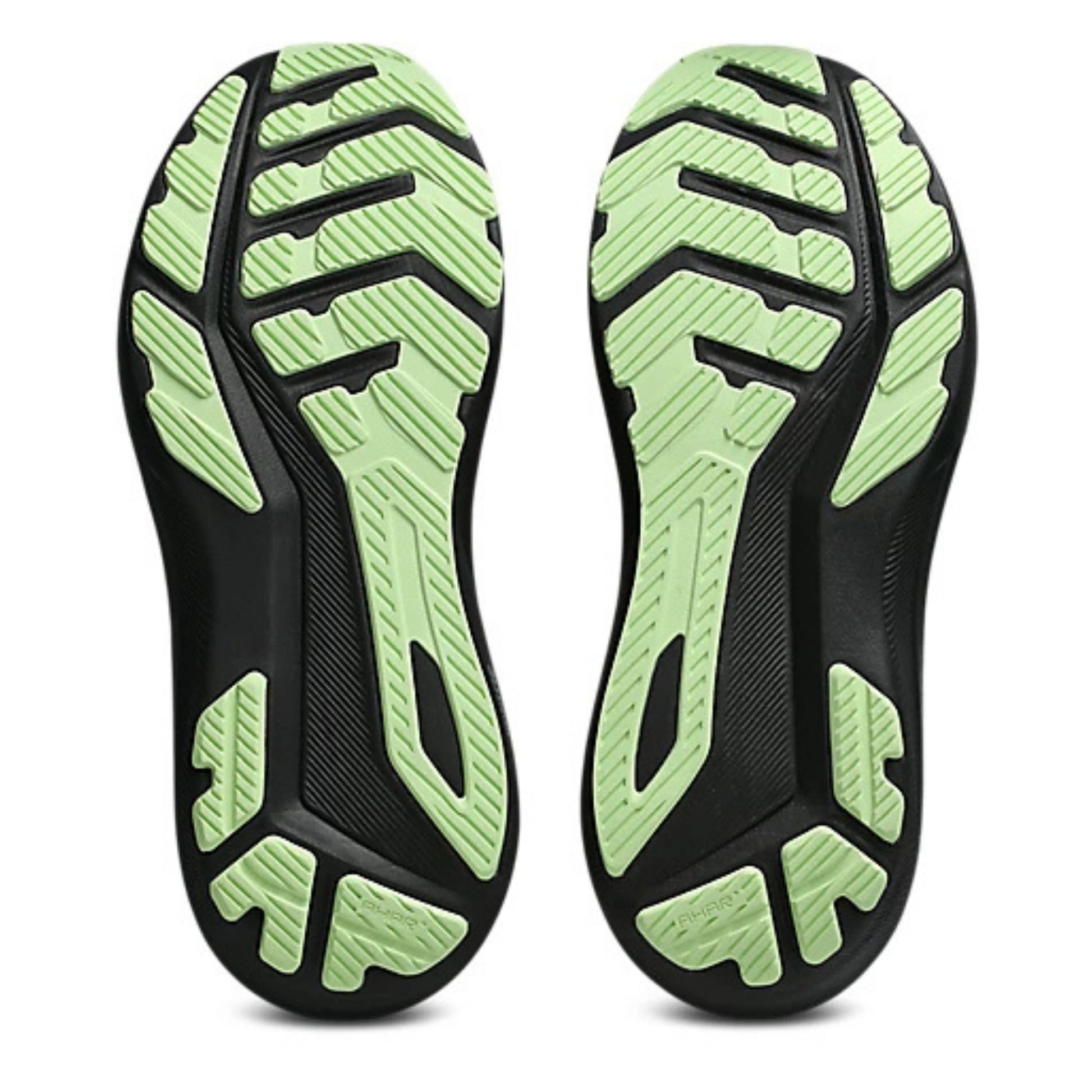Close-up of black and green running shoe soles on a white background