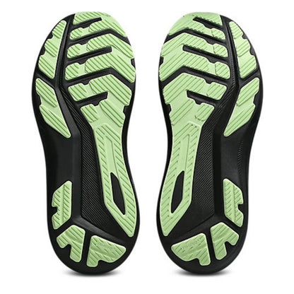 Close-up of black and green running shoe soles on a white background