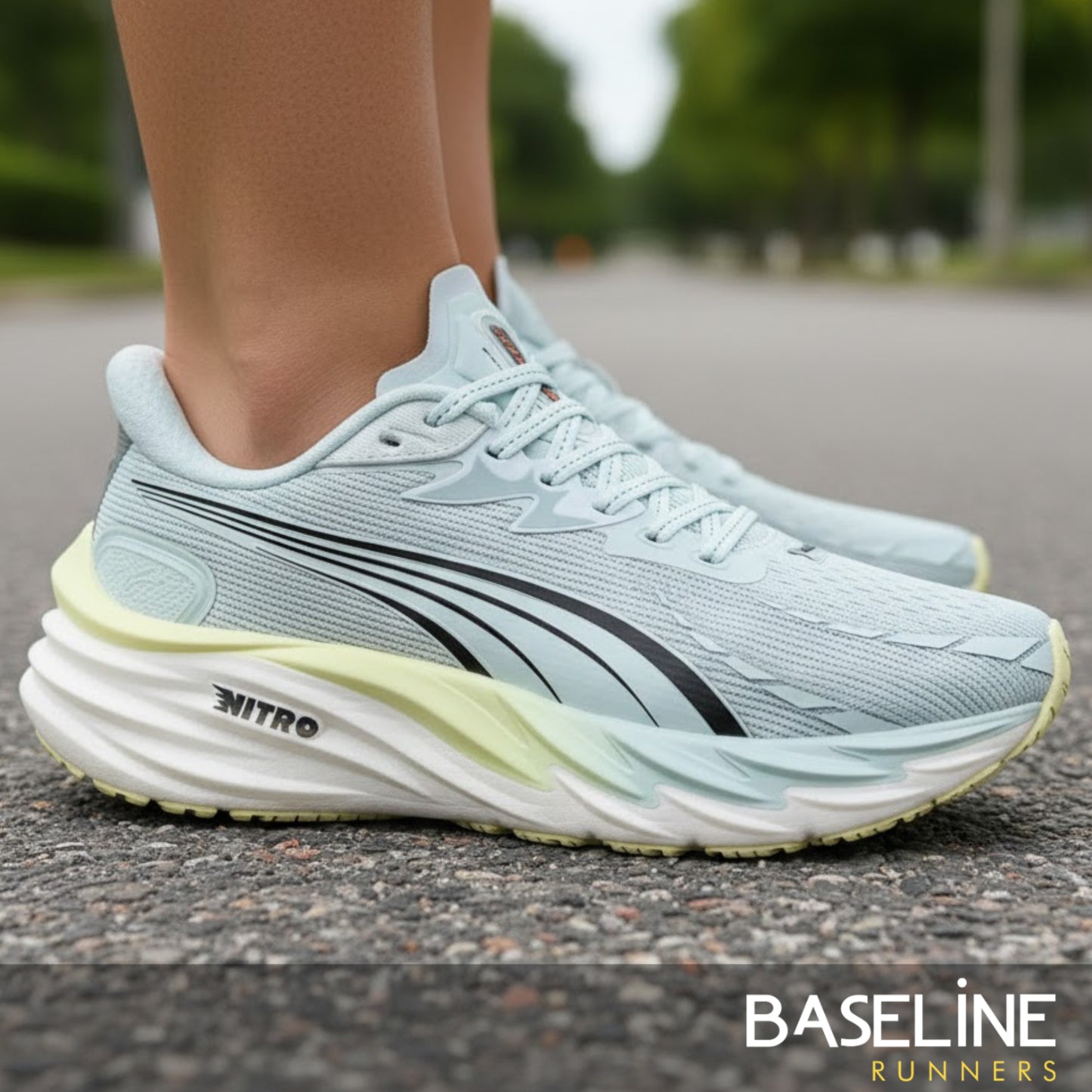 Light blue running shoe with a yellow sole on a road, featuring 'Baseline Runners' branding.