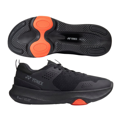 Black Yonex running shoe with orange sole on a white background