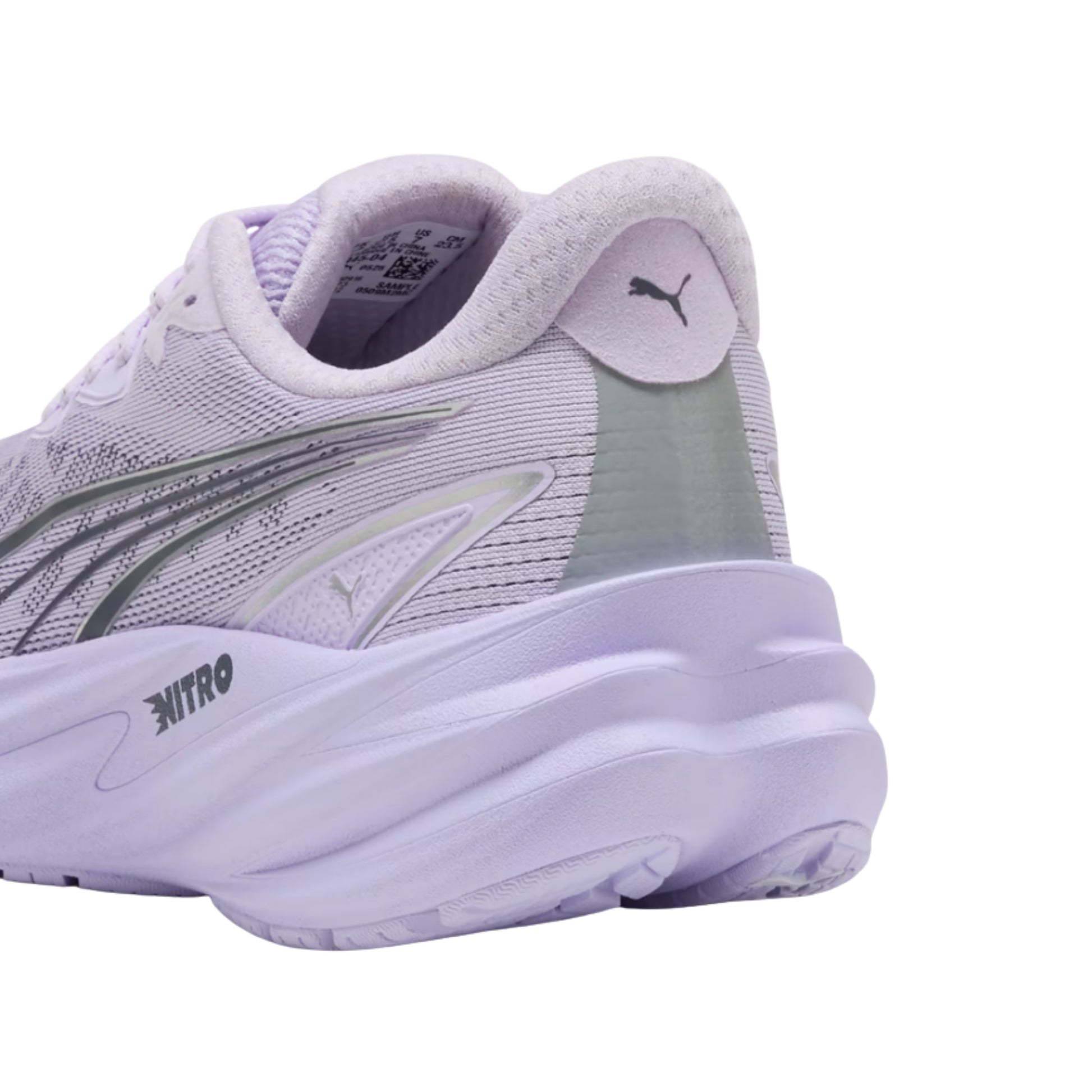 A close-up rear three-quarter view of a Puma running shoe in light lavender purple, featuring a textured mesh upper, a thick cushioned sole, and the Puma cat logo on the heel tab.