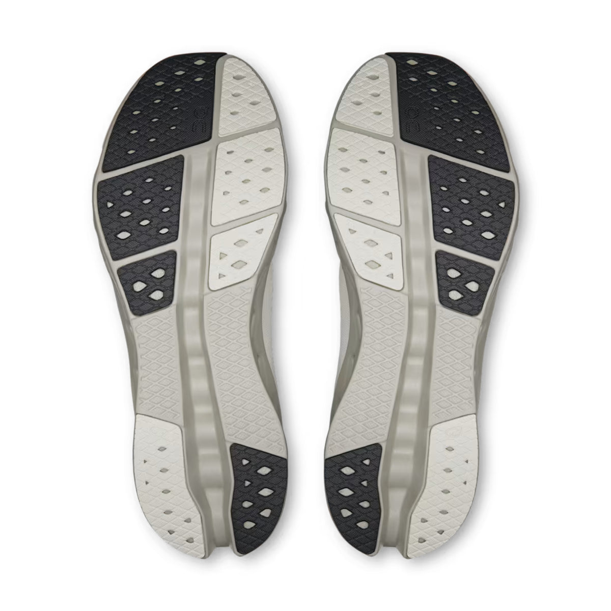 A pair of athletic shoe soles shown from the bottom, featuring a light gray and white design with black textured grip sections, photographed on a clean white background.