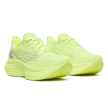 Pair of neon green Saucony running shoes on a white background