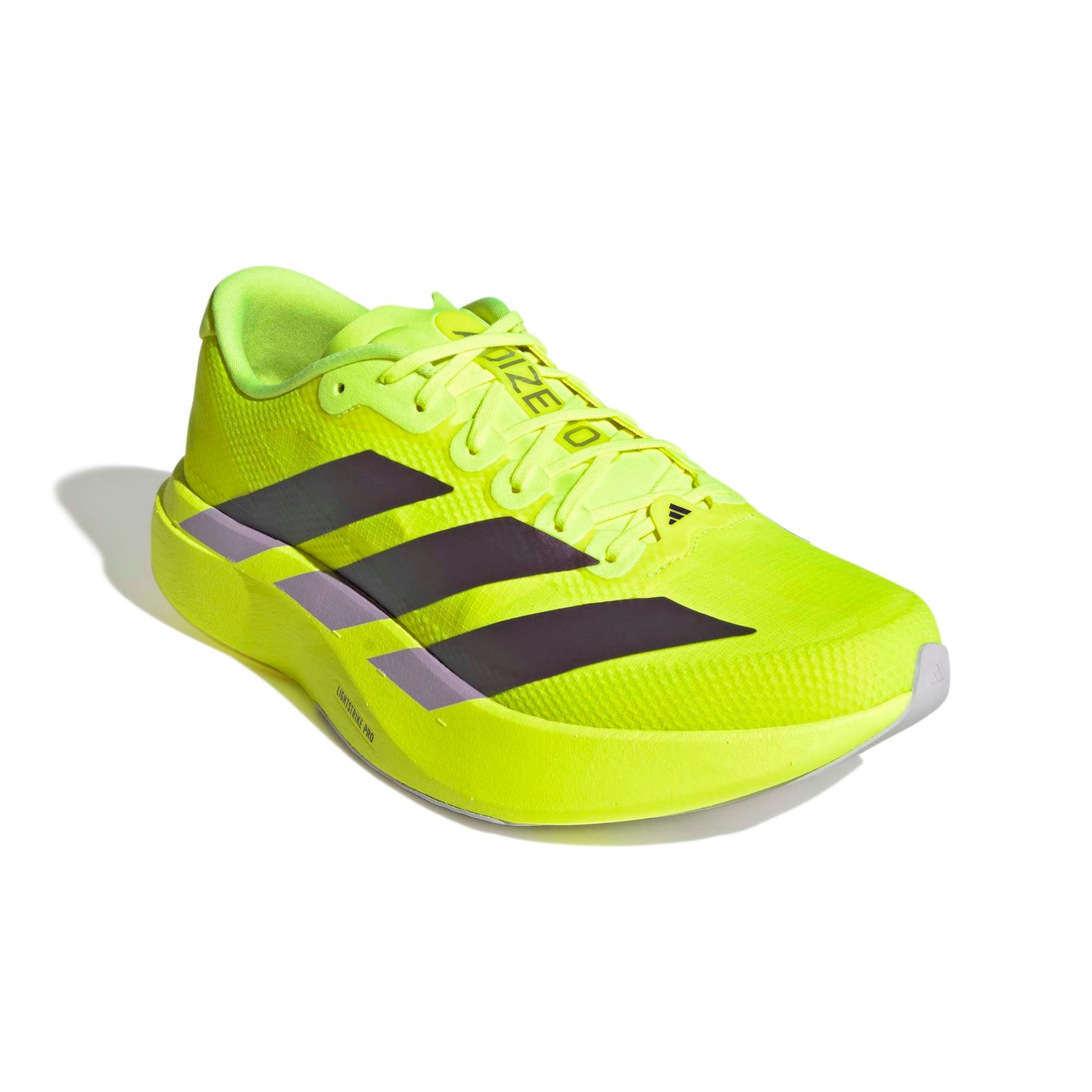 Bright yellow adidas shoe with black stripes on a white background