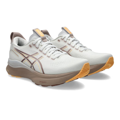 White running shoes with brown and orange accents on a white background