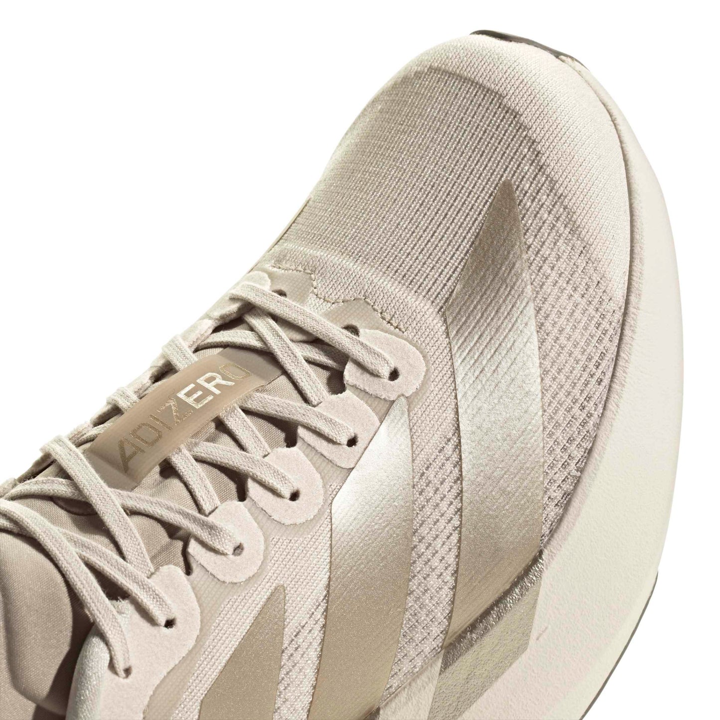 Beige Adidas running shoe on a white background