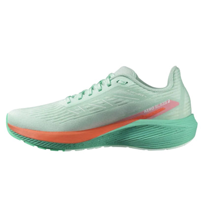 Light green running shoe with orange sole on a white background
