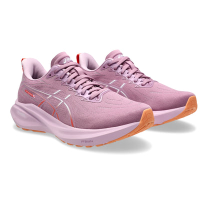 Pair of ube running shoes with orange soles on a white background