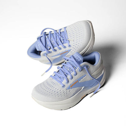 Pair of blue and white running shoes on a white background