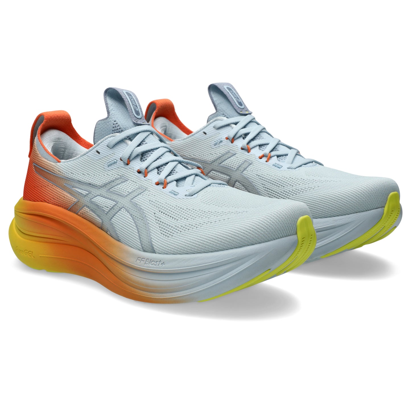 Pair of white and orange Asics shoes with yellow accents on a white background