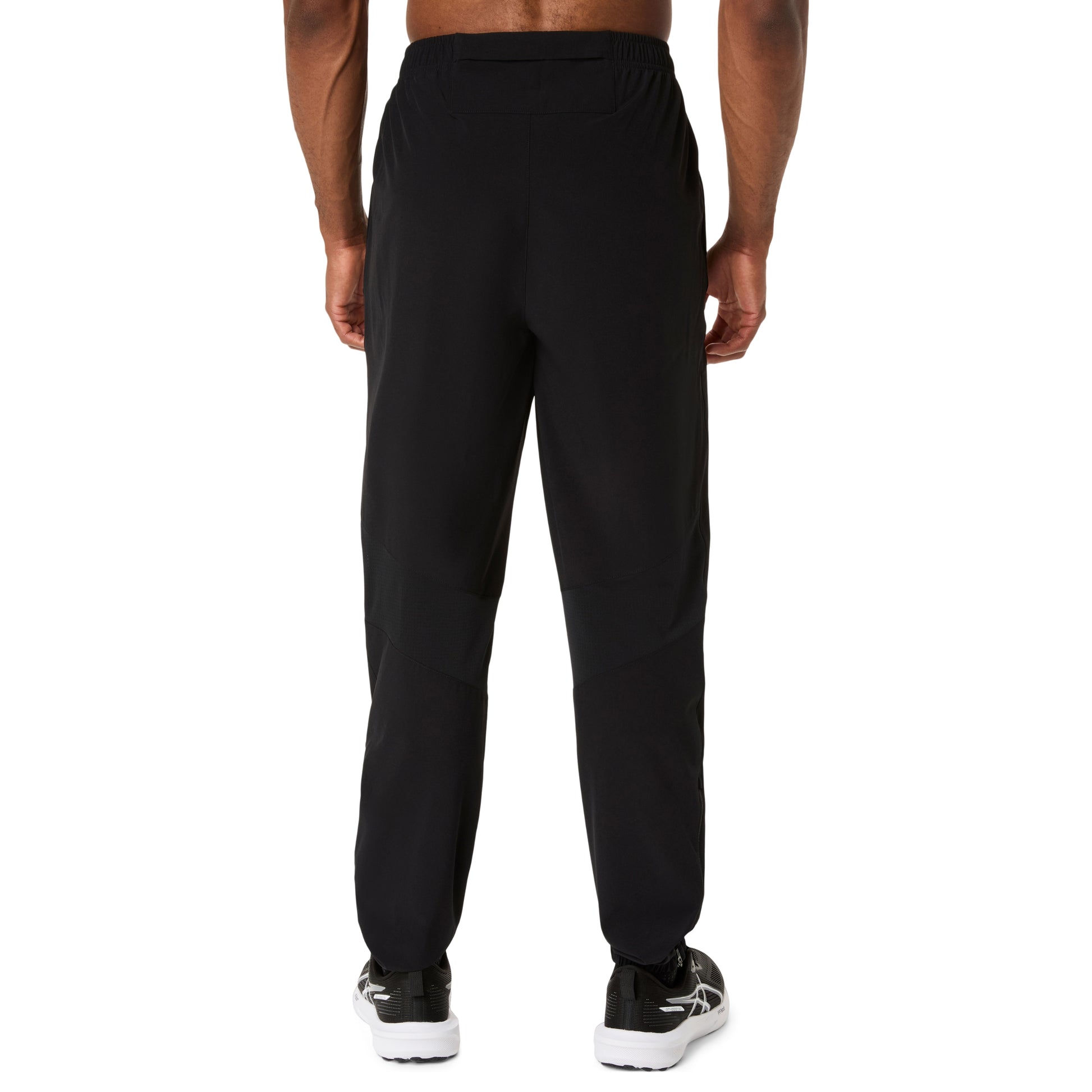 Black pants worn by a person on a white background