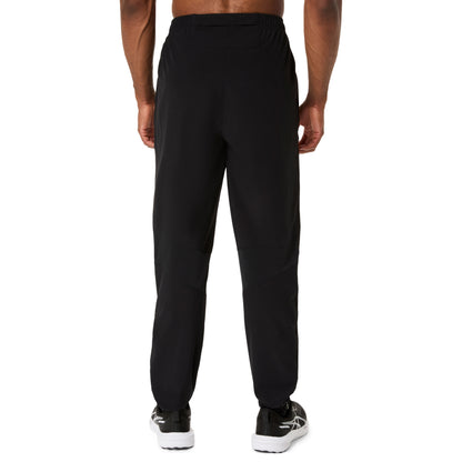 Black pants worn by a person on a white background