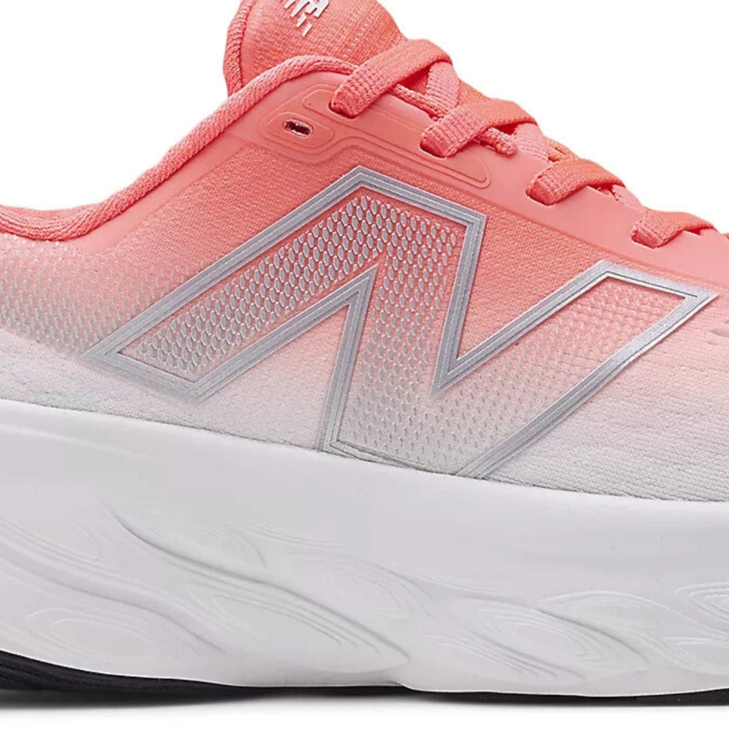 Red and white running shoe with New Balance logo on a white background