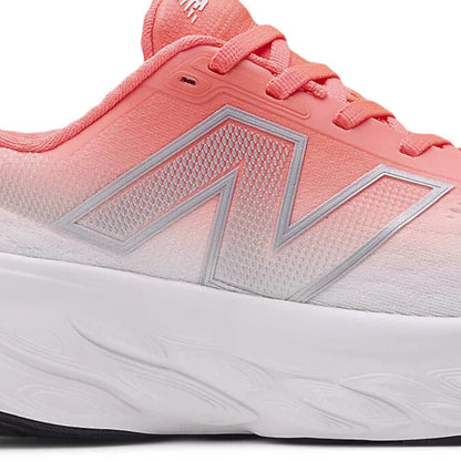 Red and white running shoe with New Balance logo on a white background