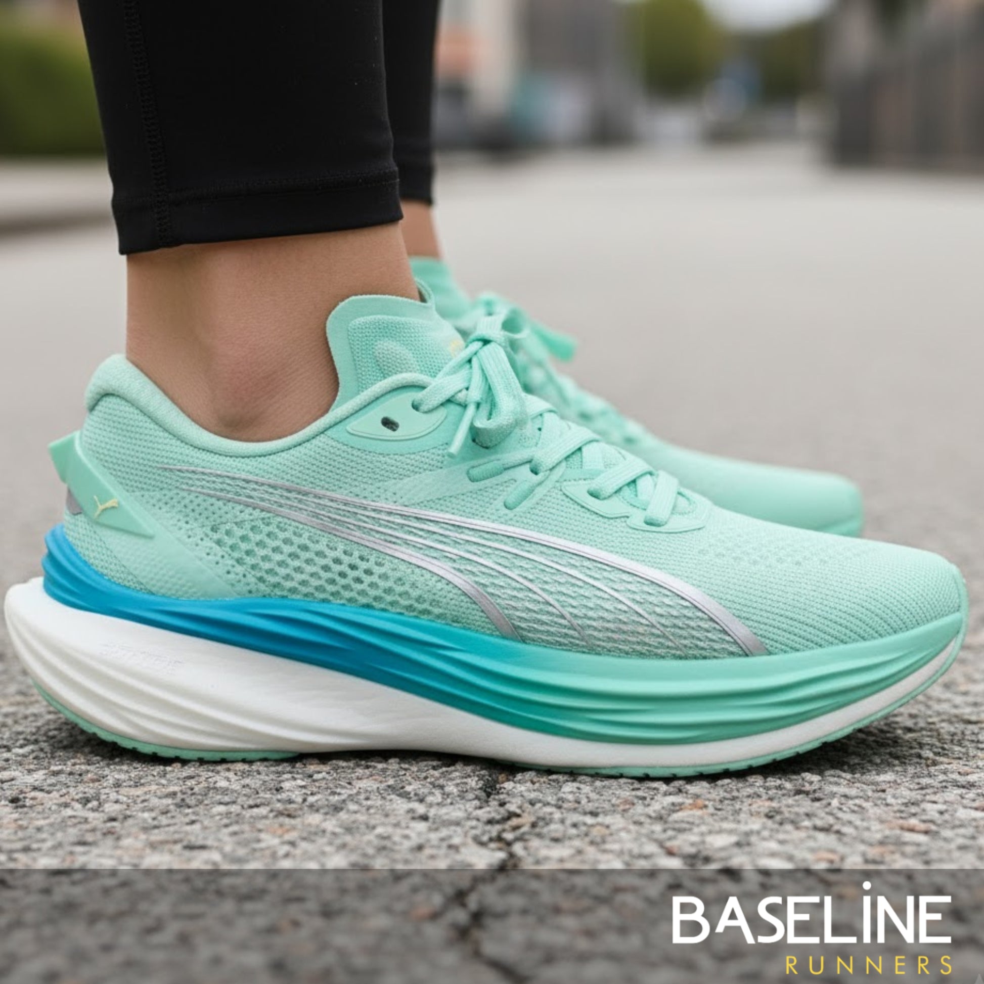 Mint green running shoes with white sole on a blurred street background, featuring 'Baseline Runners' branding.