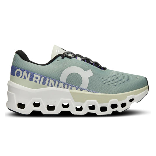 Green running shoe with white sole on a white background